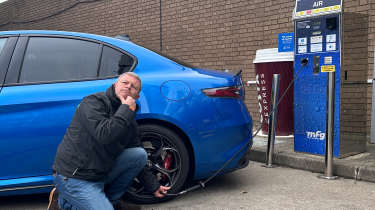 Auto Express contributor Steve Stucliffe pumping up the Alfa Romeo Giulia Quadrifoglio's rear nearside tyre